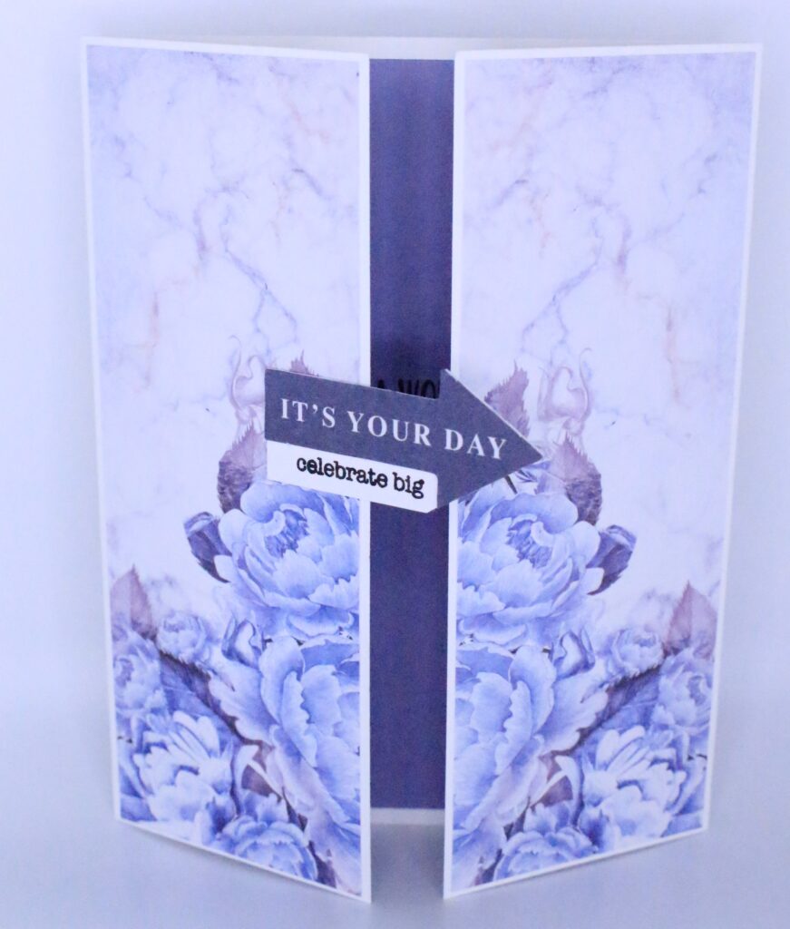 Floral gatefold card that opens in the middle and has an arrow that says "It's your day, celebrate big"