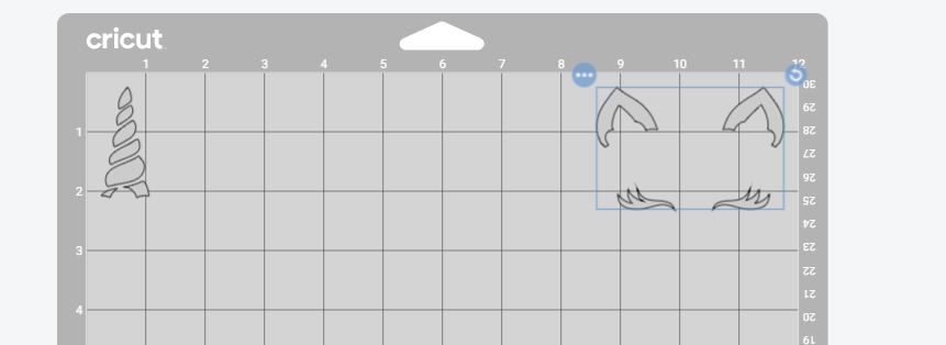 Screenshot of Cricut Design Space with unicorn horn and unicorn ears and eyelashes on same mat