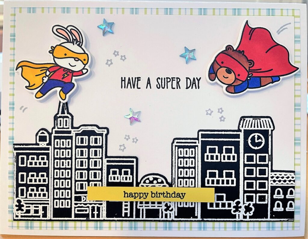 Birthday card with cartoon animal superheroes flying over a black cityscape