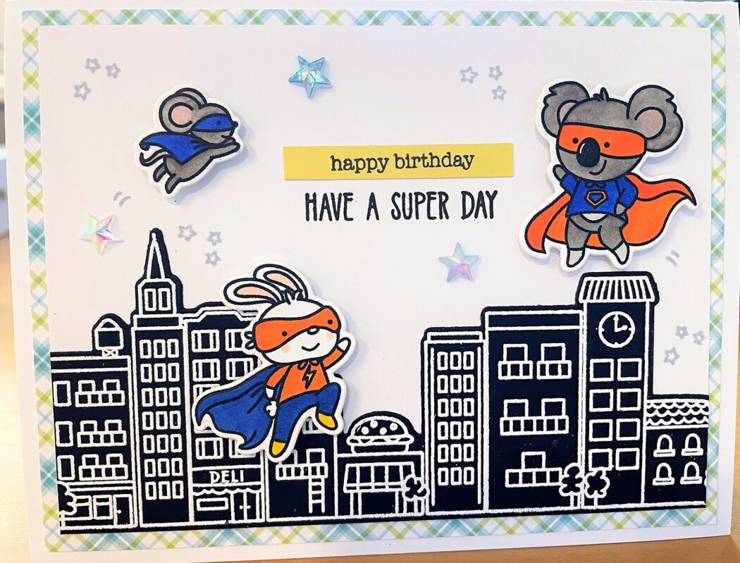 Birthday card with animal superheroes and cityscape