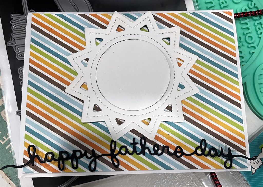 Card with striped paper and die cut sun with Happy Father's Day die cut across bottom