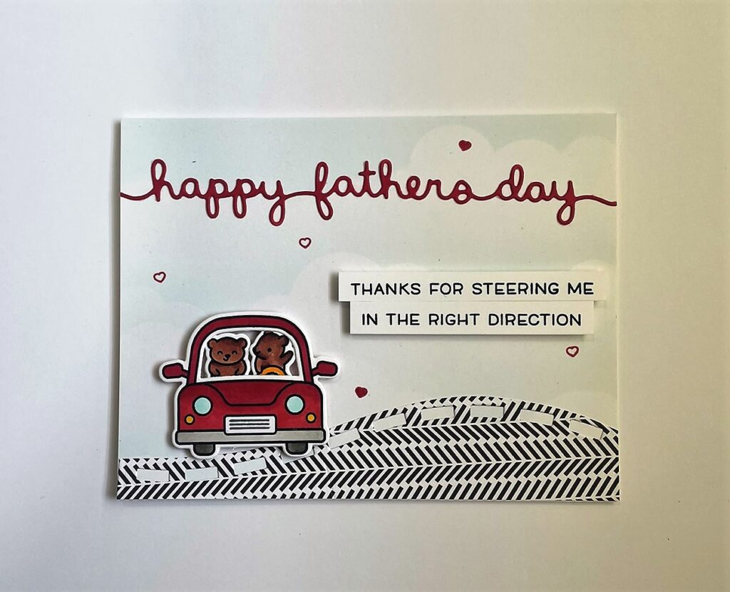 Happy Father's Day card with two little bears in a red car on the road that says Happy Father's Day at the top of the card and "thanks for steering me in the right direction" next to the car