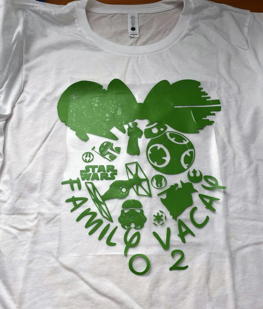 Green Mandalorian themed Minnie Mouse profile and Family Vacay 2022 on top of a white t-shirt